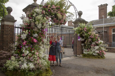 RHS Chelsea Flower Show 2023. Iron gates decorated with British blooms by Marlston Farm Girl and The Unwalled Garden.