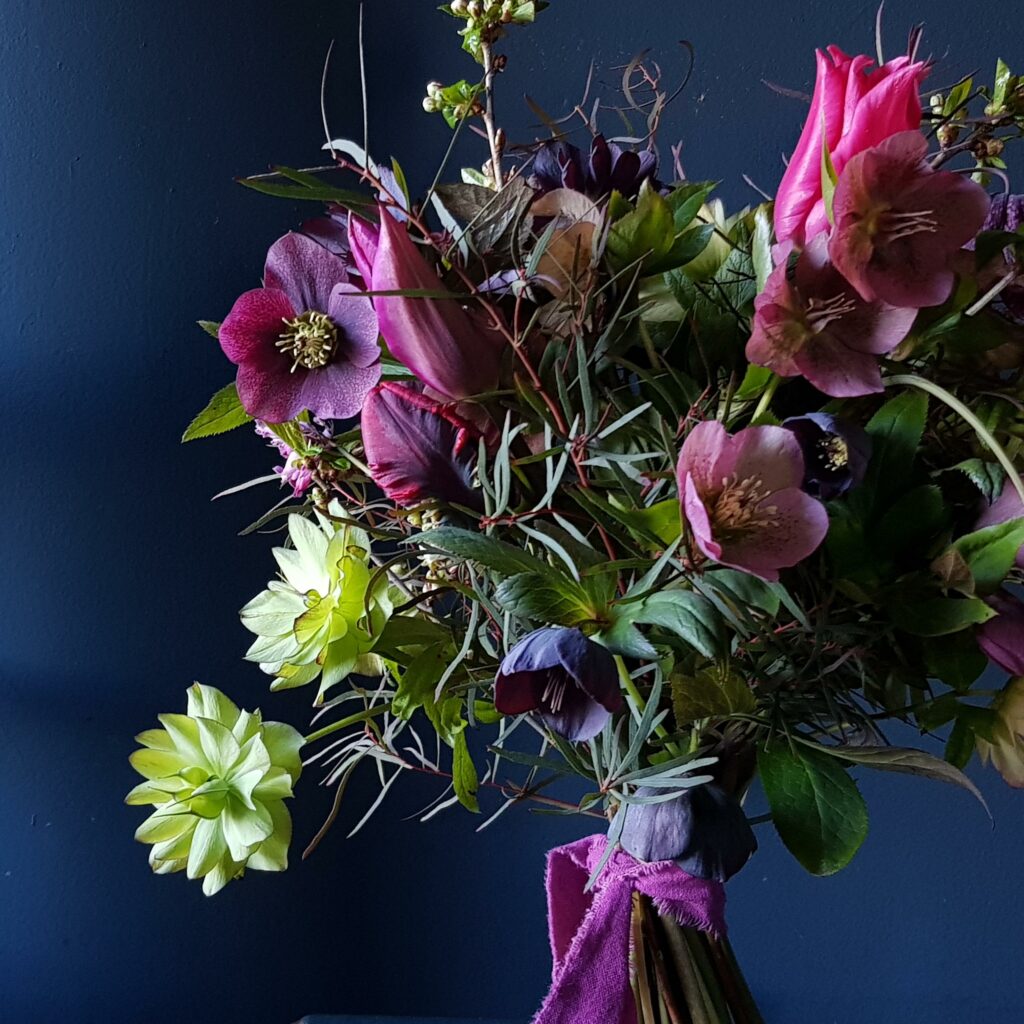 Northumbrian Flowers spring bouquet with deep purple and green hellebores.