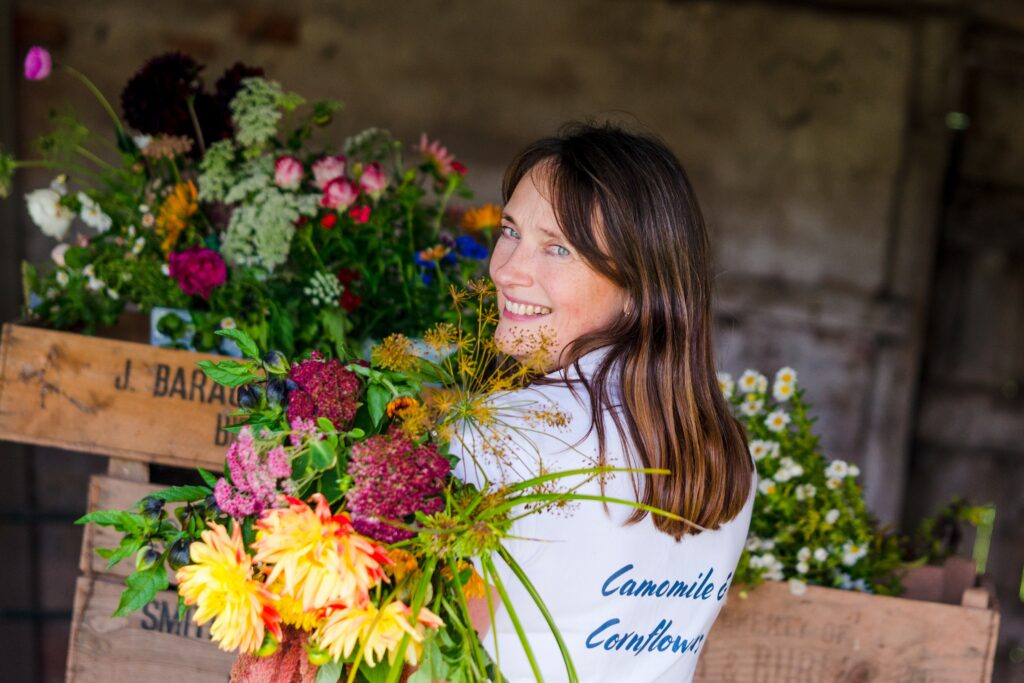 Kate of Camomile and Cornflowers holds a colourful late summer bouquet