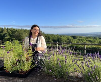 Emma-Jae is pictured outdoors in her flower plot tending lavender.