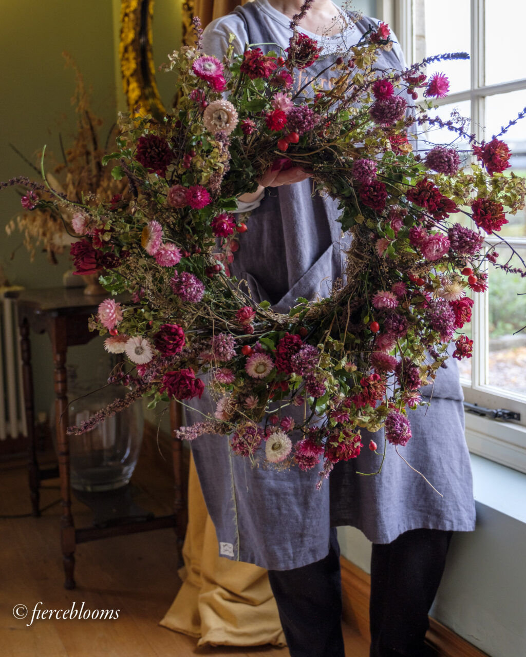 A wreath brimming with sustainable flowers, grown with the seasons using chemical free methods. Pink helichrysum do cartwheels in this glorious wild creation by Fierceblooms, Cheshire.