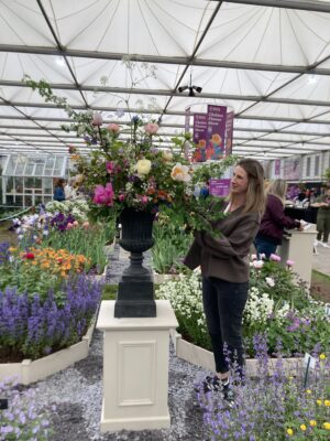 Luna Blooms arranges British cut flowers in a tall urn for RHS Chelsea 2023