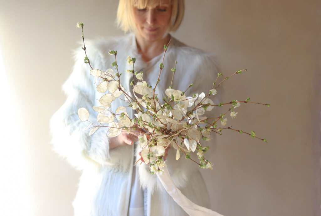 An ethereal bouquet of winter flowering honeysuckle and dried honesty created by Cissy Bullock to showcase seasonal flowers in January