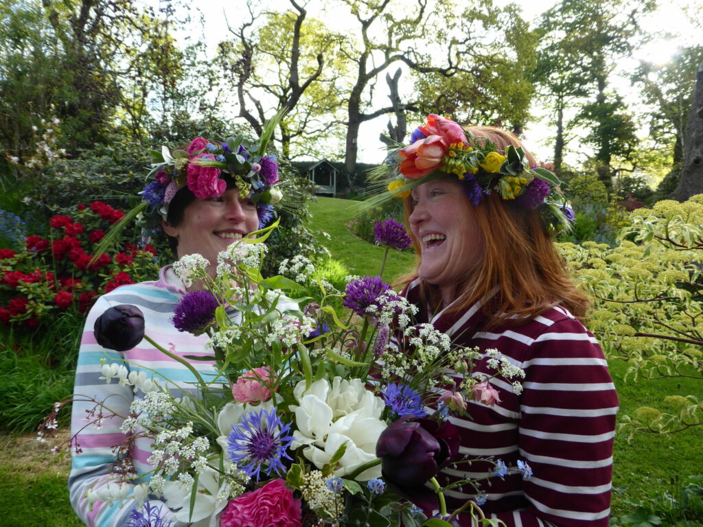 Pam of Quirky Flowers laughs in the garden with her sister at a flower crown workshop