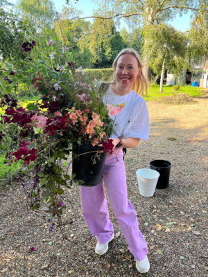 Saija Sitolahti holds a bucket of freshly picked local flowers after her visit to the Meadow at Moss Lane.