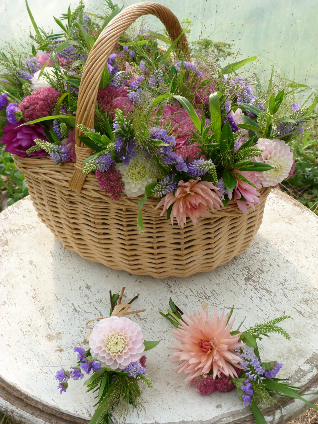 A rattan basket filled with summer flowers for a funeral by The Sussex Cutting Garden.