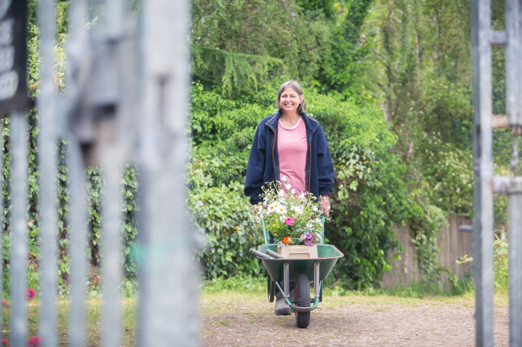 Famous locally as 'the wheelbarrow lady' Carole pushes her flowers back from her allotment regularly
