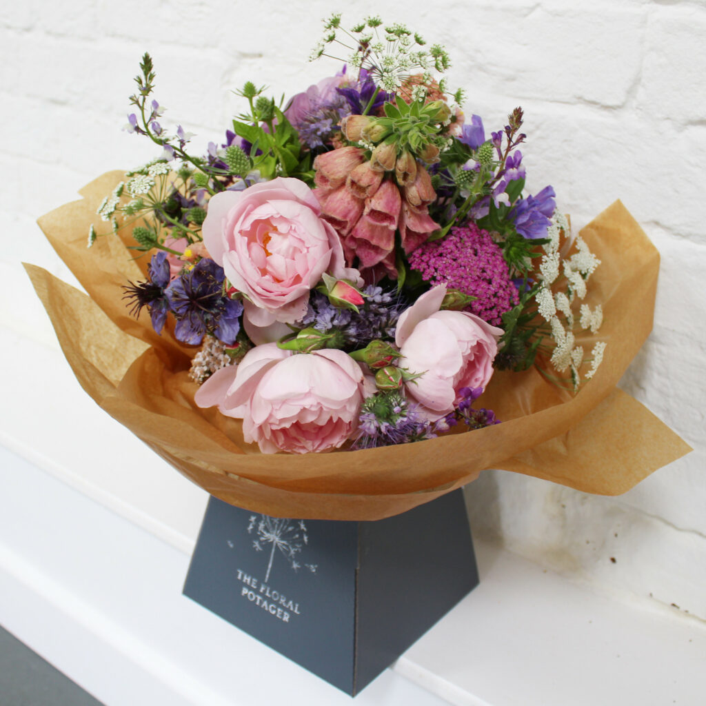 The Floral Potager presents a beautifully wrapped bouquet of soft scented pink garden roses and early summer ingredients from her cutting garden.