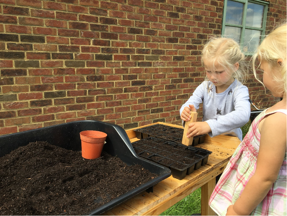 Starting them young! Carolyn's children help with sowing seeds for British cut flowers at Pembridge Farm