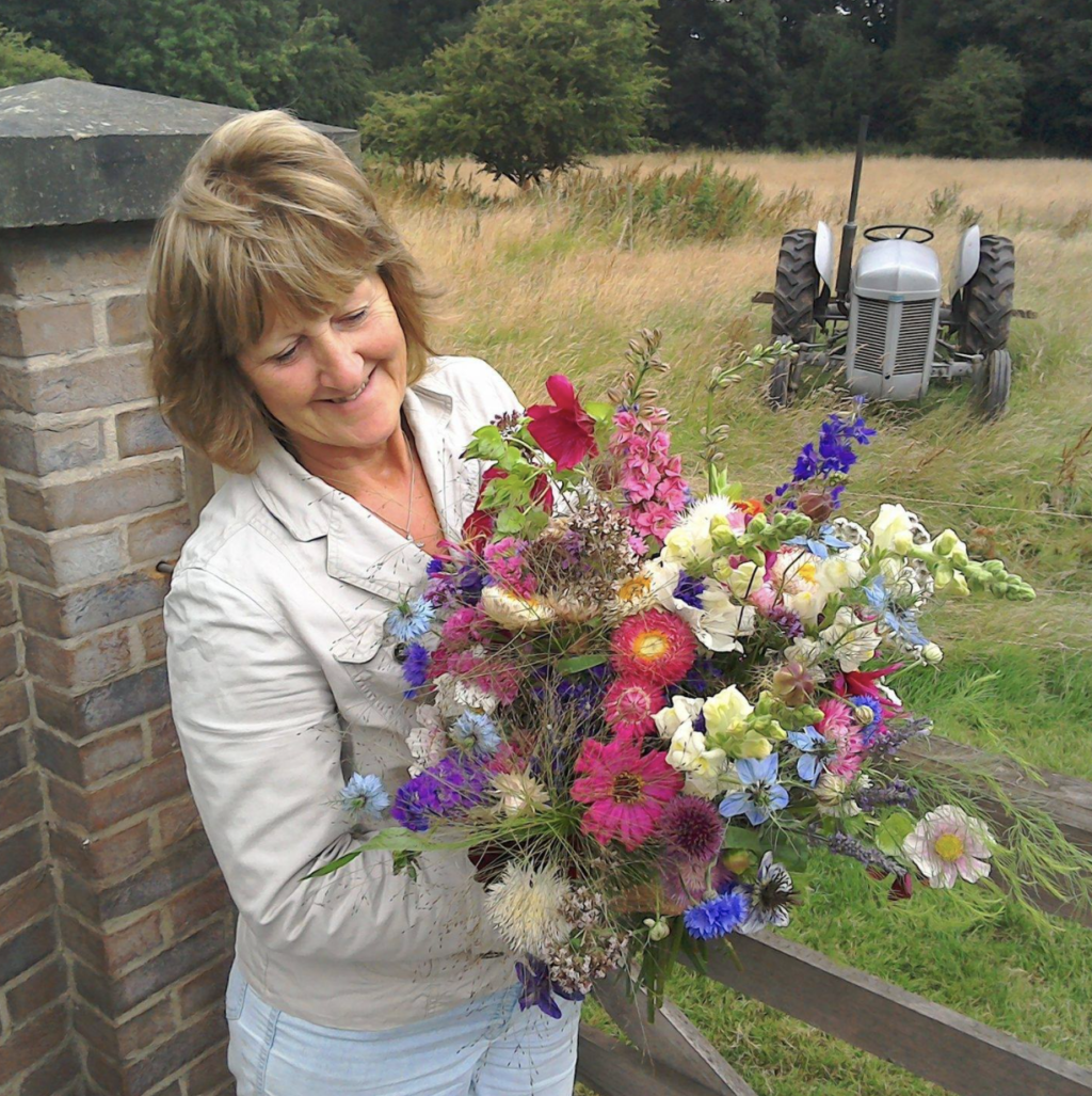 Sandra Bright of Peacock Cottage Flowers holds a colourful bouquet of British cut flowers