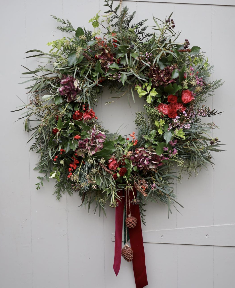 An evergreen explosion with red berries and ribbon. Fresh Christmas wreath by Tangle and Thyme, Essex